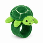 Green plush turtle slap bracelet on a white background