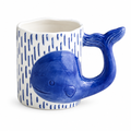 White ceramic mug with a blue 3D whale and whale tail handle on a white background