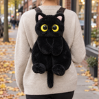 Adult wearing the black plush cat backpack on an autumn sidewalk