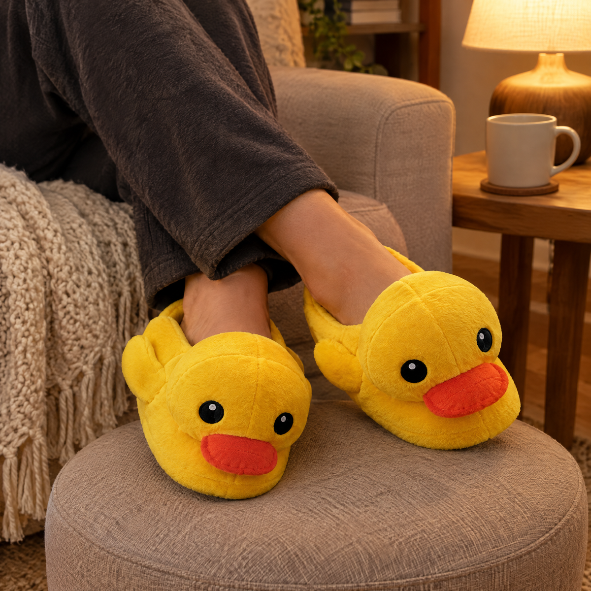 Yellow Duck Plush Slippers worn with ankles crossed on a footstool in warm lamp light